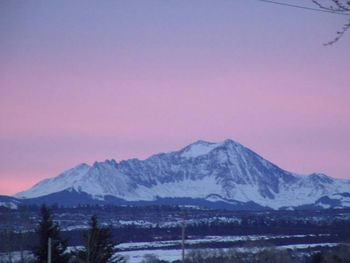 Scenic view of snow covered mountains against sky