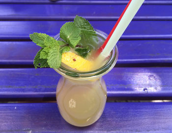 High angle view of glass of lemonade on table 