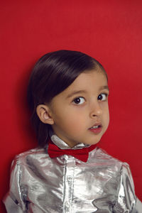 Christmas portrait of a 4 year old boy in a silver shirt and a red bow tie