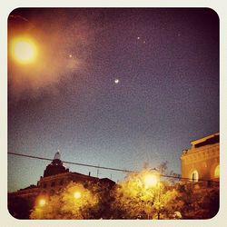 Low angle view of illuminated street light against sky at night