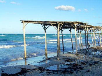 Lifeguard hut on beach against sky