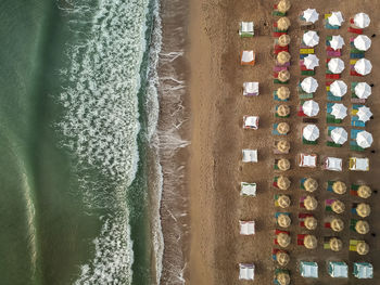 High angle view of beach umbrellas by sea