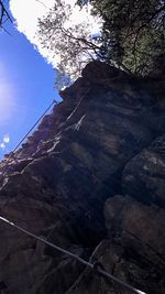 Low angle view of tree mountain against sky