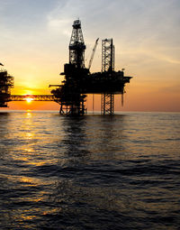 Offshore gas production platform at sunset