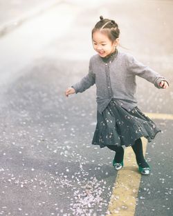 Portrait of girl walking on wet street