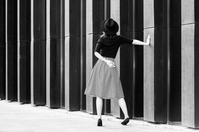 Full length of woman standing by railing