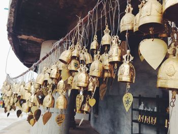 Low angle view of thai bells hanging on cable