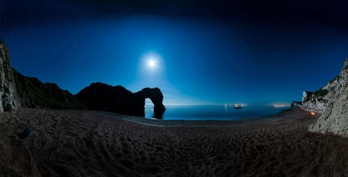 Scenic view of sea against sky at night