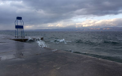 Winter cloudy landscape on lake beach. shortly before sunset.