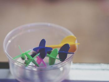 Close-up of multi colored glass on table