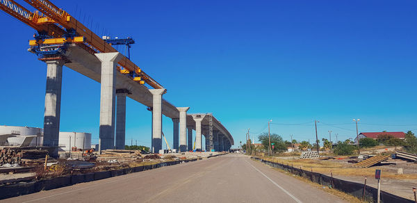 View of construction site against clear blue sky