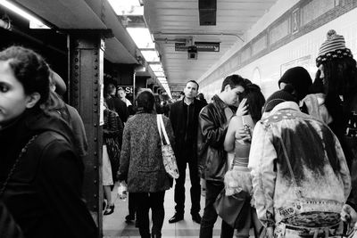 Group of people walking on railway station platform