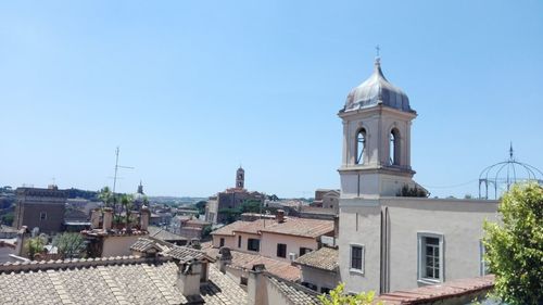 View of buildings in city against clear sky