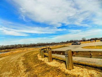 Scenic view of field against cloudy sky