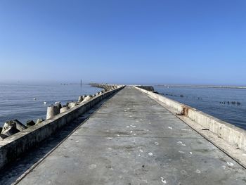 View of pier over sea against clear sky