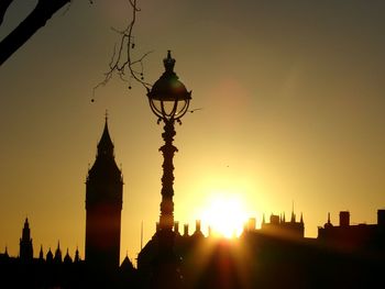 Silhouette big ben in city against sky during sunset