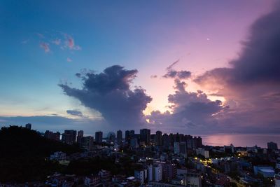 Scenic view of buildings against sky during sunset