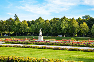 Statue in park against sky