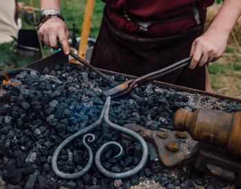 High angle view of man working on barbecue grill