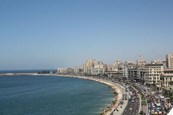 HIGH ANGLE VIEW OF CITYSCAPE AT SEASIDE