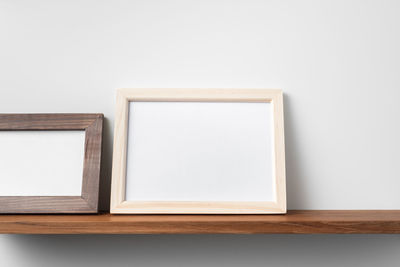 Close-up of empty table against white background