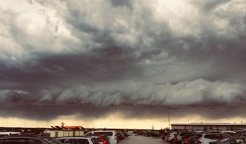 Storm clouds over buildings during sunset