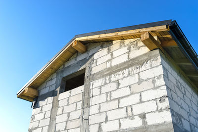 Low angle view of building against clear blue sky