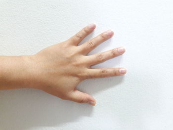 Close-up of human hand against white background