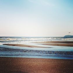 Scenic view of beach against clear sky