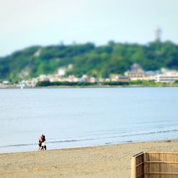 People at beach against sky