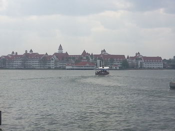 Boats in river with buildings in background