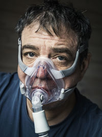 Coronavirus patient man in oxygen mask close-up face