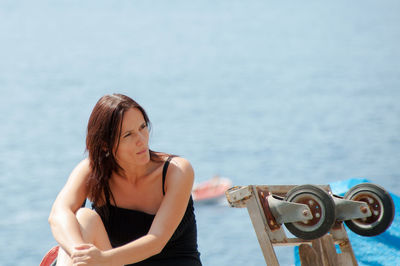 Young woman standing on railing