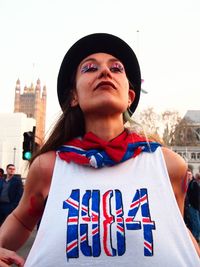 Portrait of young woman standing in city