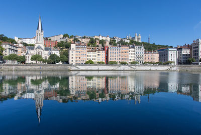 View of the saint-georges church in old lyon, the fourvière hill and the saône quays in summer