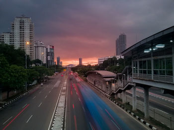 View of city street and buildings at dusk