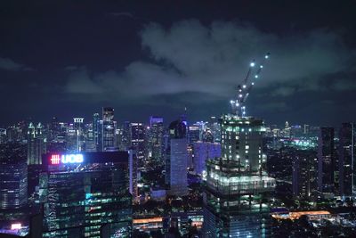 Panoramic view of illuminated buildings against sky at night