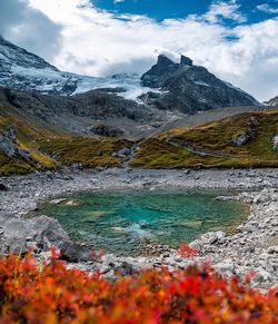 Scenic view of lake by mountains against sky