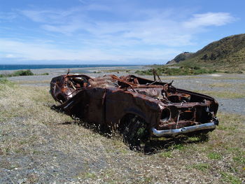 Abandoned car on field