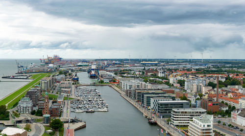 High angle view of buildings by sea against sky