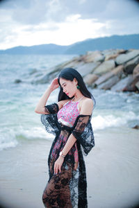 Young woman standing at beach