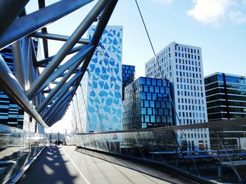 Footbridge against buildings in city