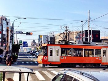 Cars moving on railroad track in city