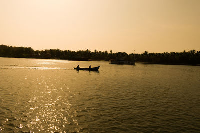 Scenic view of lake against clear sky during sunset