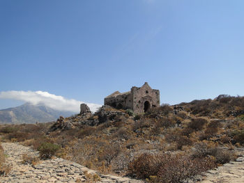 Castle on mountain against clear sky