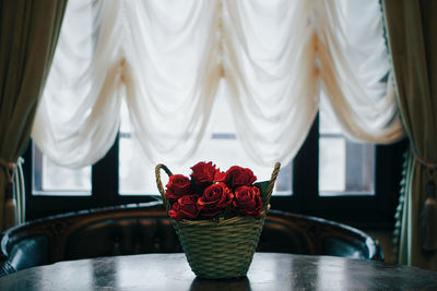 Red roses in basket on table