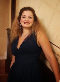 Portrait of a smiling young woman standing at home