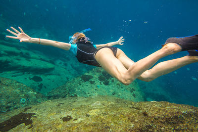 Young woman swimming in sea