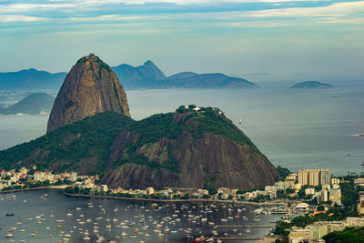 Panoramic view of sea and mountains against sky