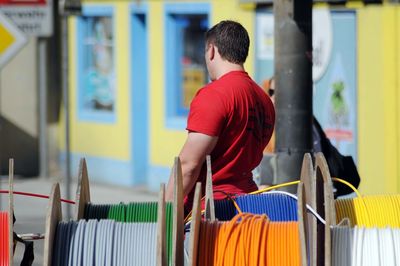 Rear view of man standing at store